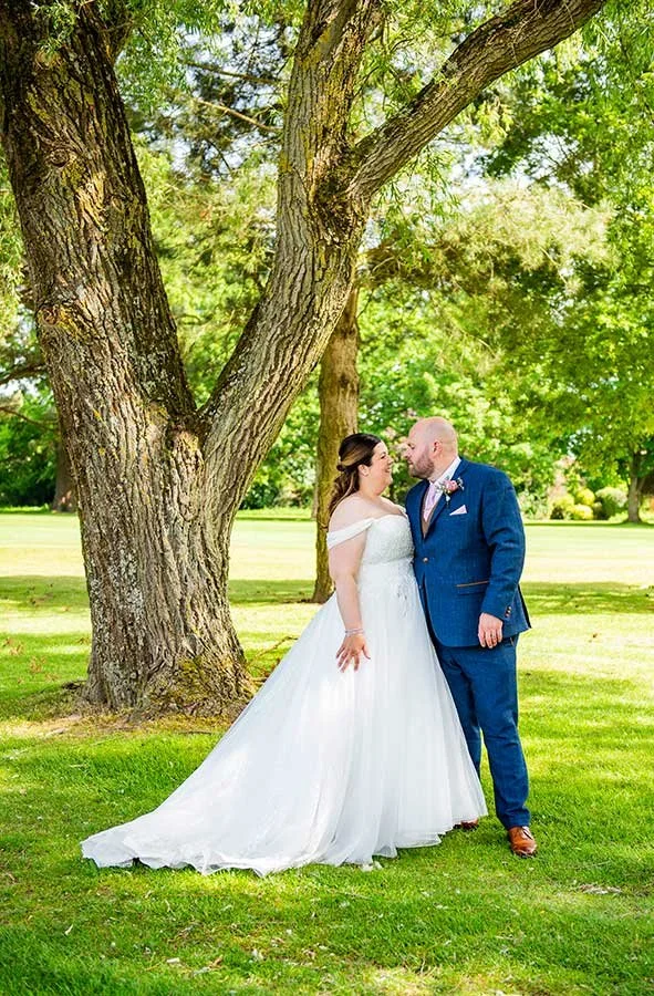 West Sussex bride and groom posing for photos at Ham Manor Golf Club in Angmering