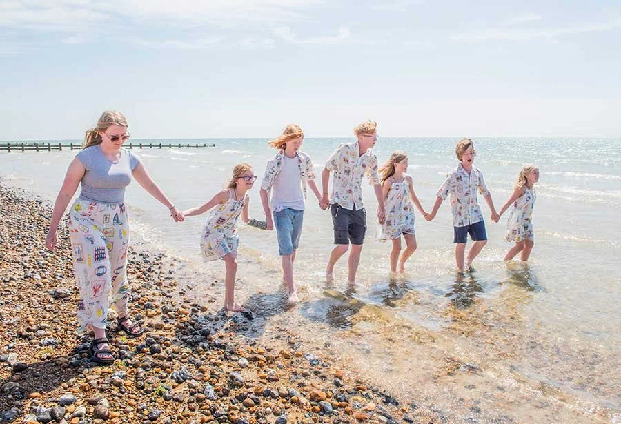 Children walking hand in hand at Littlehampton Beach photoshoot