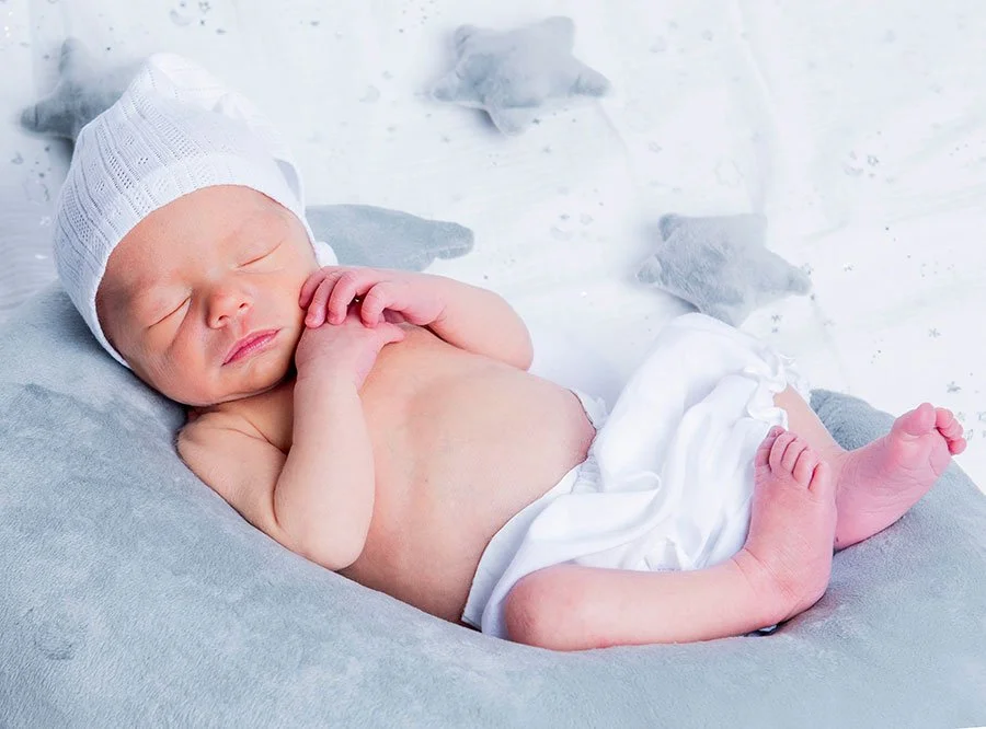 Calm and natural newborn photoshoot moment with baby in a Littlehampton studio.
