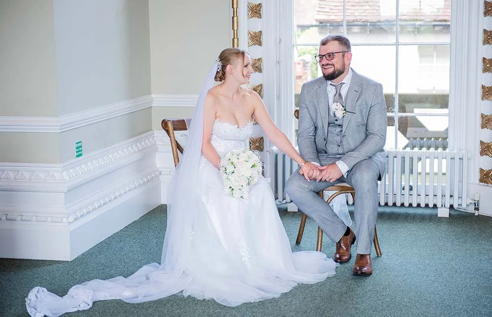Bride and groom relaxing at Arundel Town Hall after signing their wedding certificate