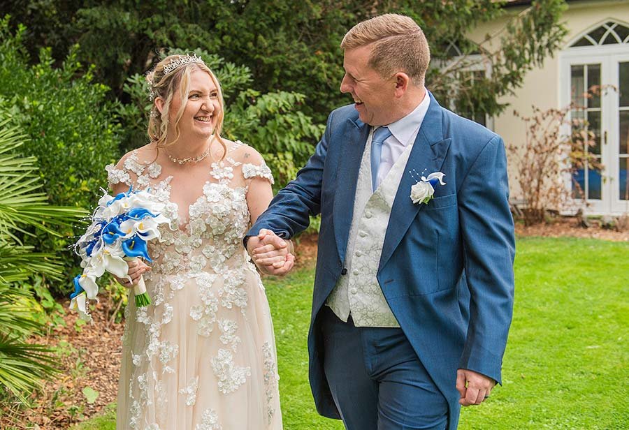 sussex bride and groom hand in hand