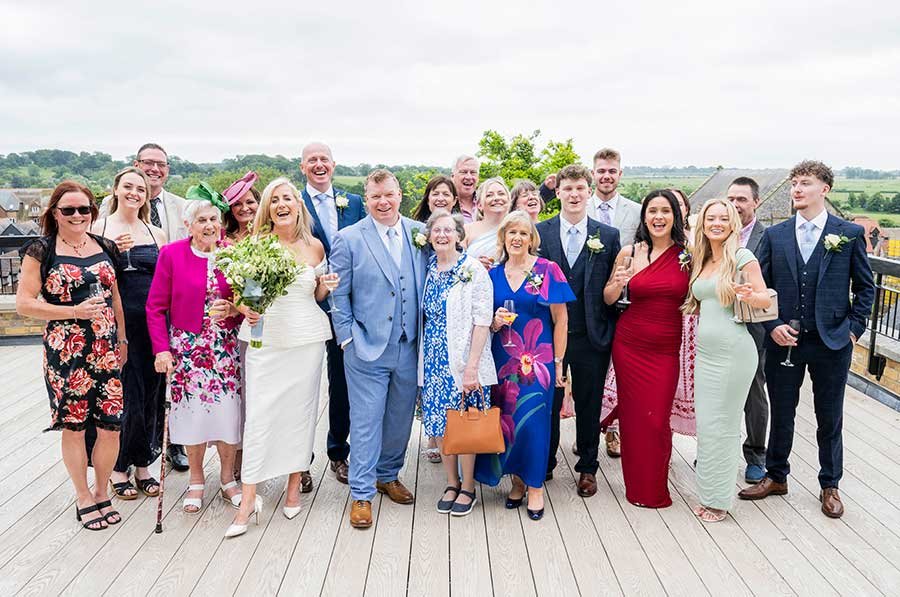 Happy newlywed couple posing with family and friends after their Arundel Town Hall wedding