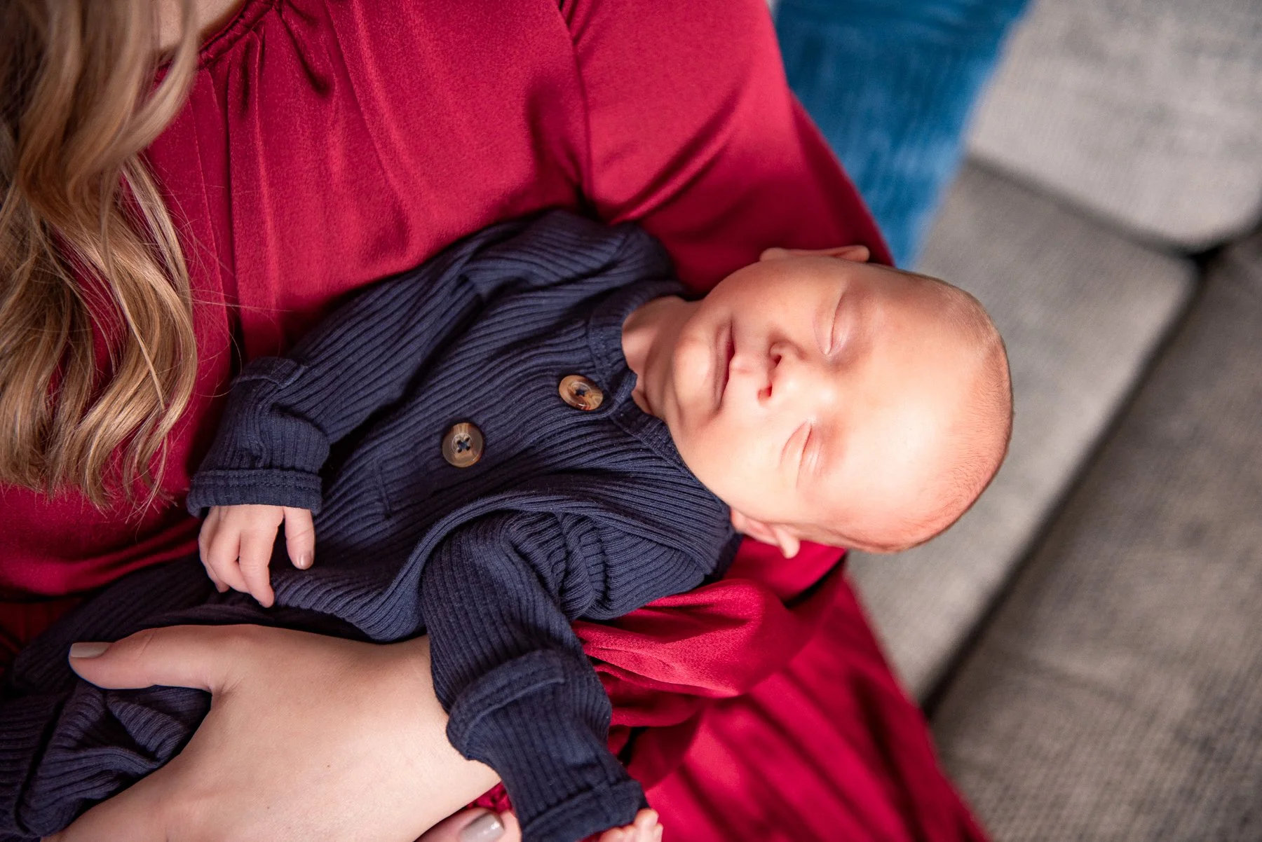 Newborn photography session Gibsonville NC — baby wrapped in red, in-home portrait