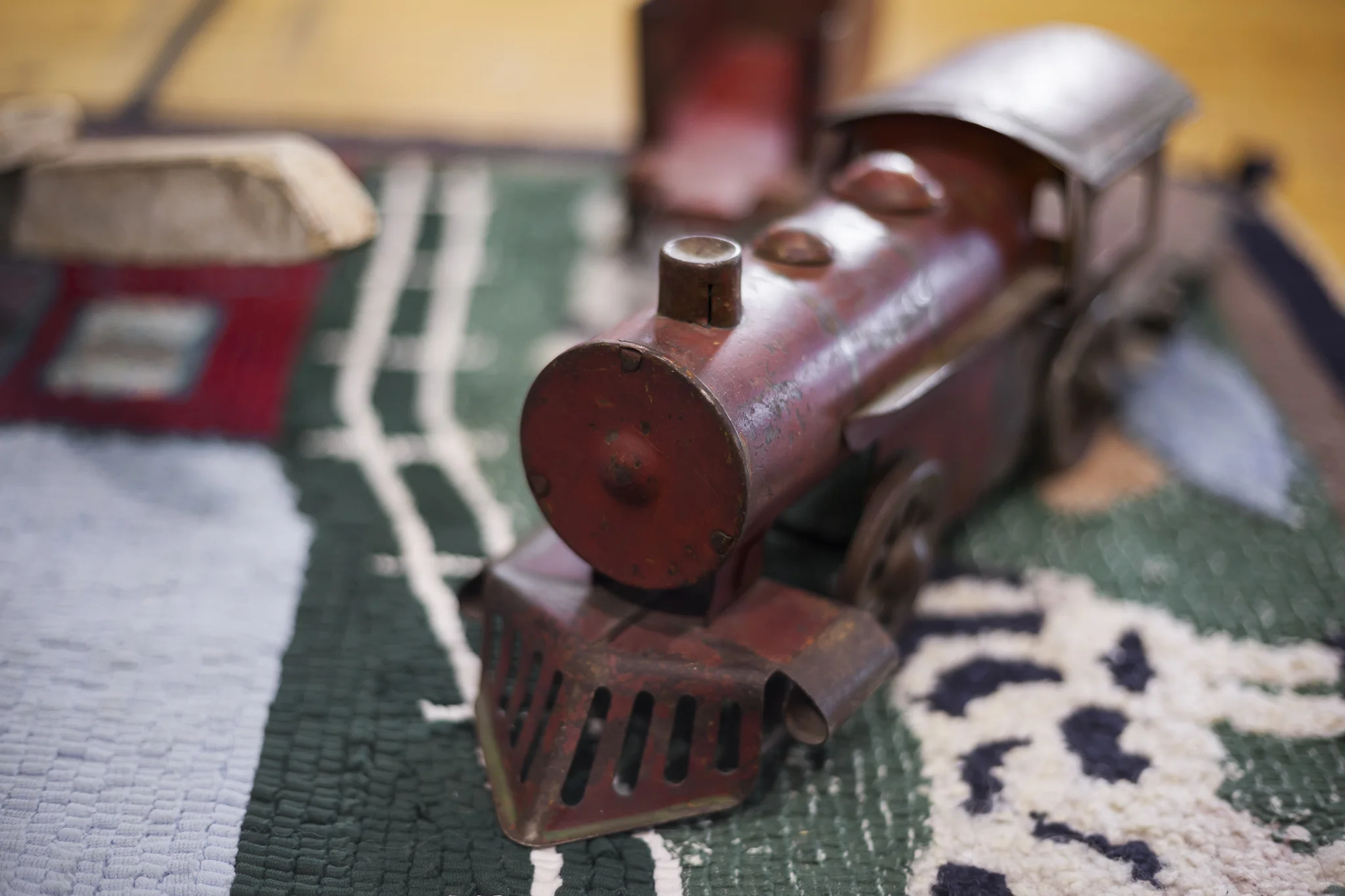 Hand Carved Wooden Train on a Woven Children's Cow Blanket