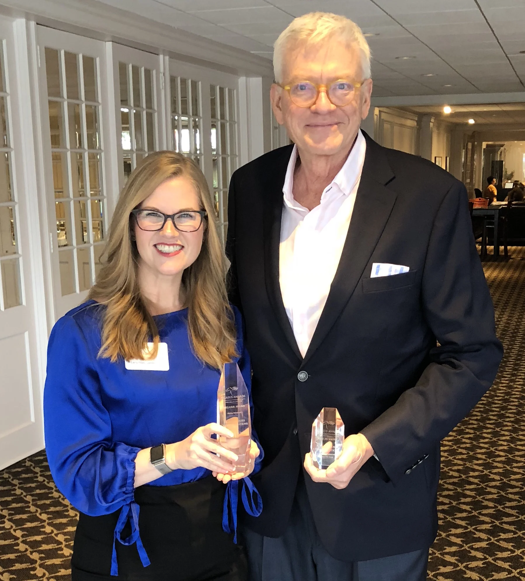 Vice President of Account Services Kristin Cole and President A. Larry Ross accept the 2018 PRSA Dallas Pegasus Awards for “Projects Best in Show” and “Media Relations, Consumer” on behalf of A. Larry Ross Communications. (A. Larry Ross Communications)