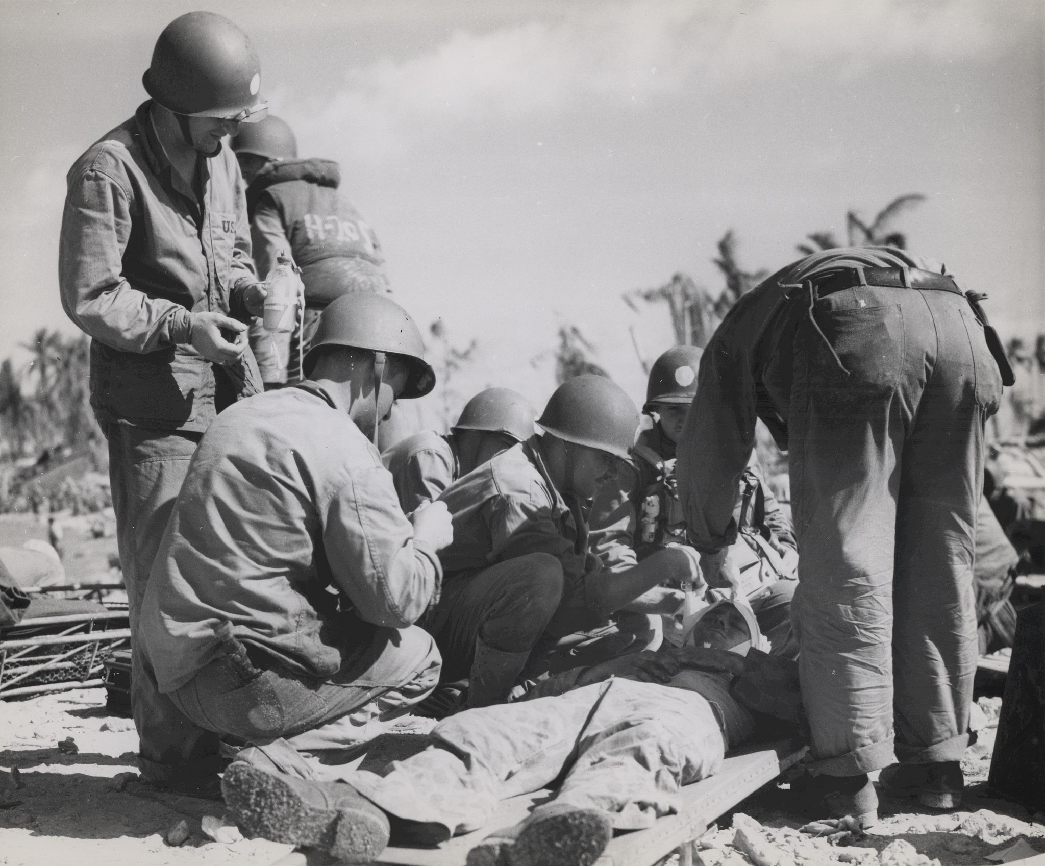USMC Archives, “Navy Corpsman Rendering Aid, Tarawa, November 1943,” Flickr , CC BY 2.0.