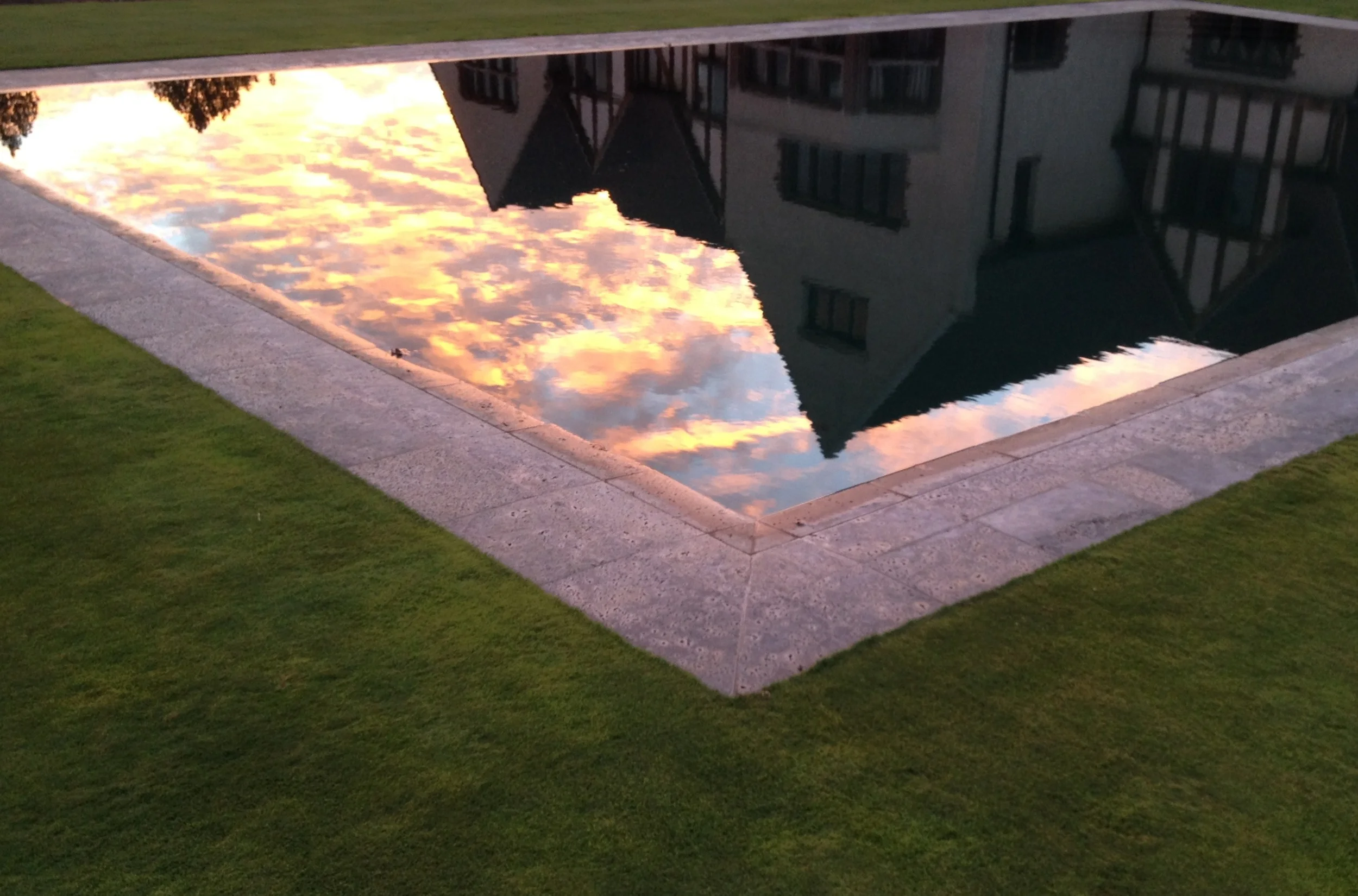 Reflection of the house in the pool at sunset.