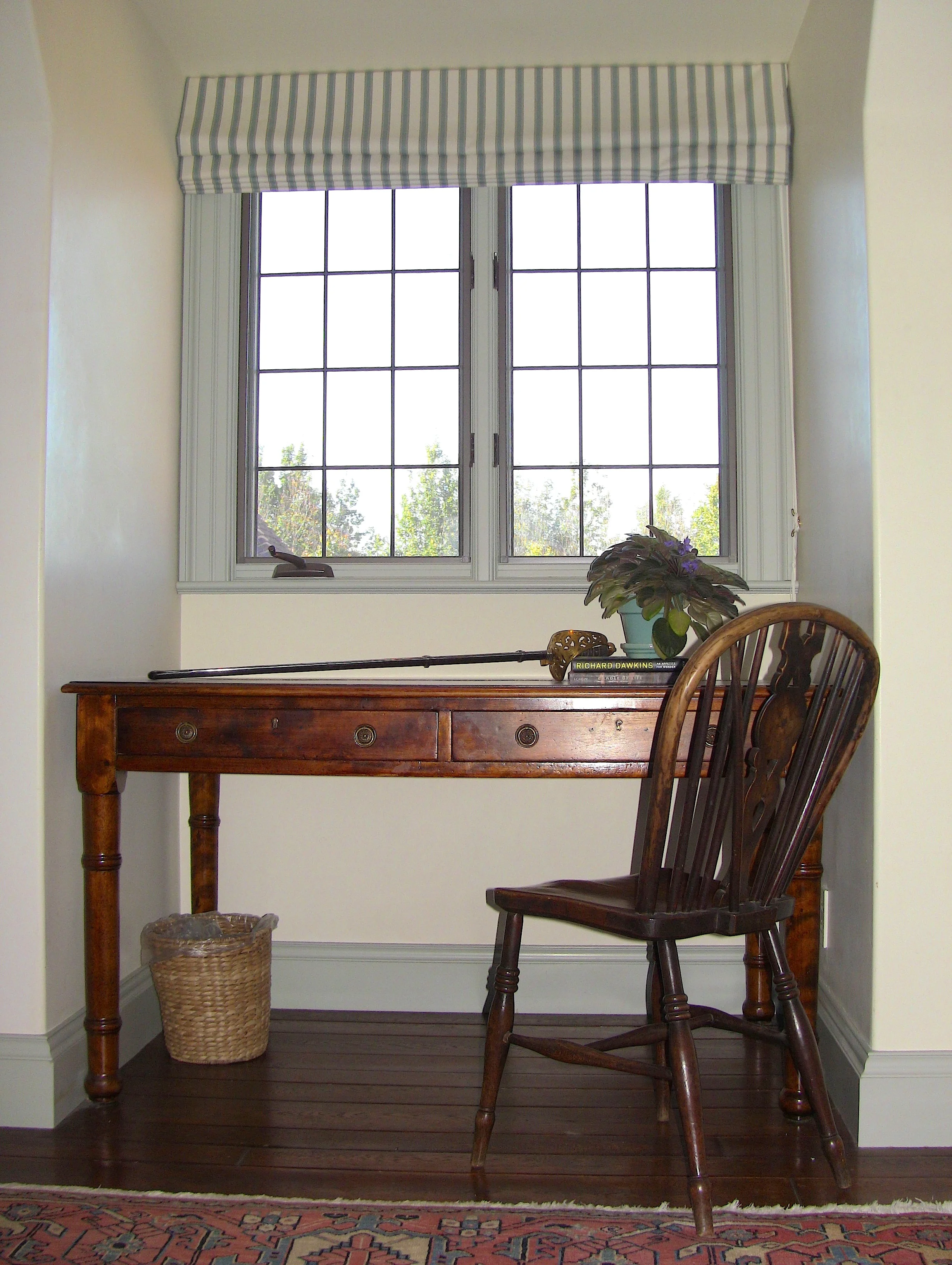On the Northwest side of the room, a dormer window accommodates perfectly an antique study desk.