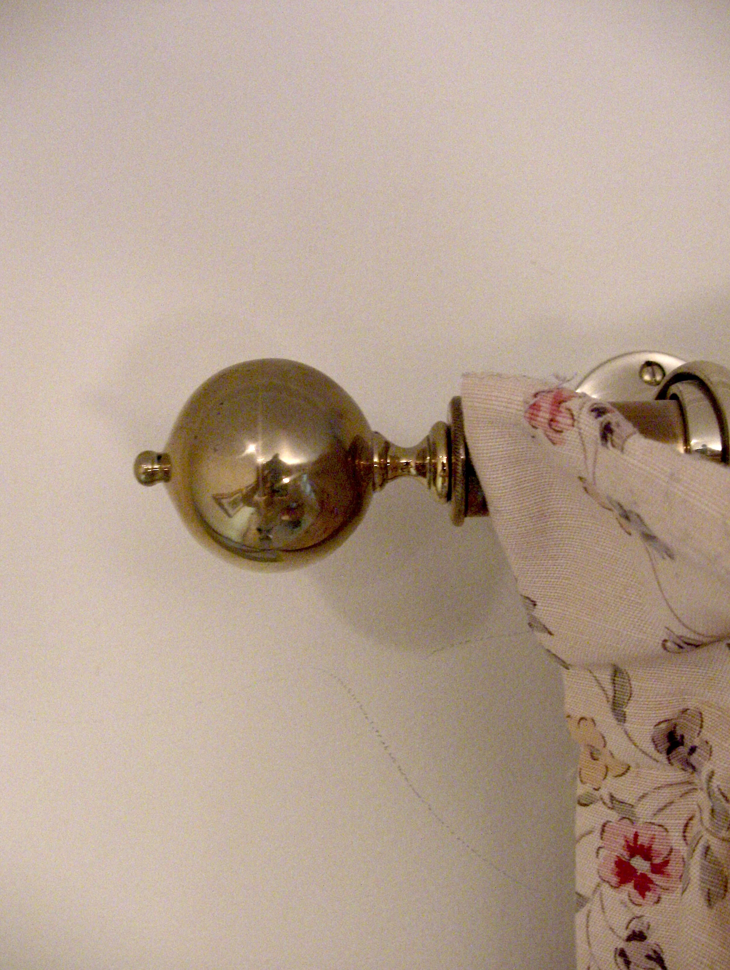 Brass curtain rods in the Morning Room and throughout the house are tipped with reproduction brass finials.&nbsp;Each is a clone of an original antique and were made in Buxhill, England by Brass Foundry Castings Ltd.