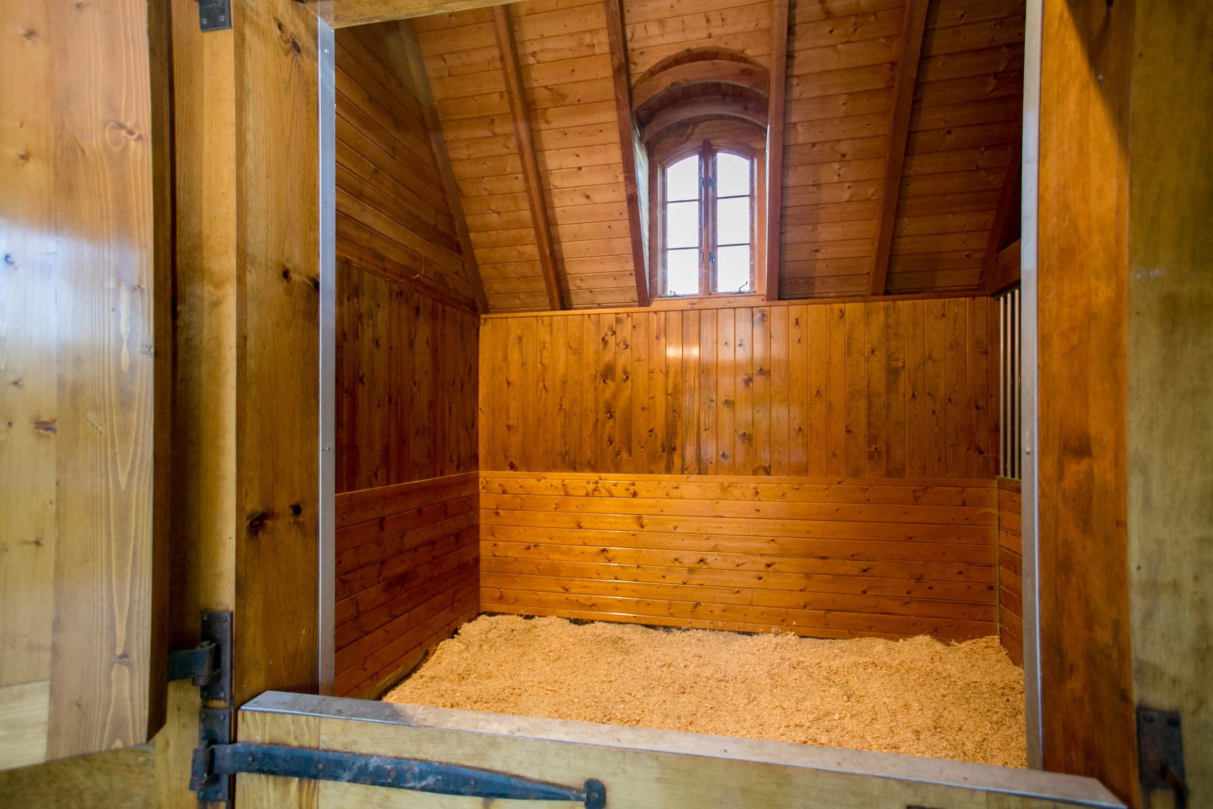 Operable casement windows in each stall for cross ventilation and light.