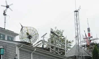 The four wind turbines on the roof of his Newport home supply electricity for everything but his clothes dryer and kitchen stove. (Tim Faulkner/ecoRI News)