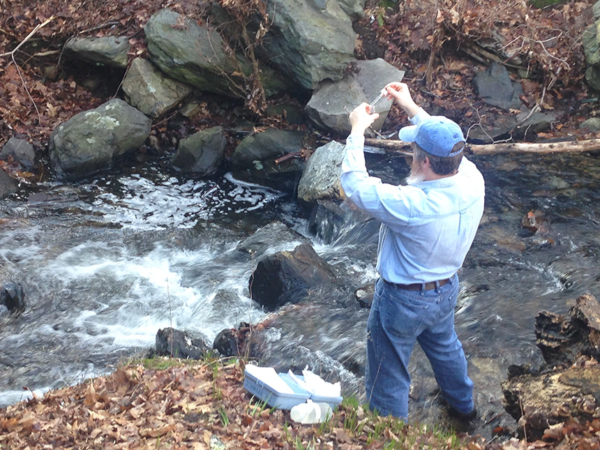 Blackstone River Coalition volunteer Michael Gravier took water samples from Mussey Brook in Lincoln, R.I., earlier this month. (Catherine Sengel/ecoRI News)