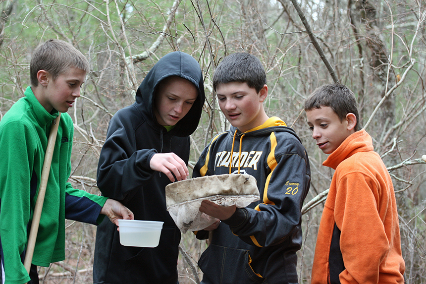 About 20 Chariho Middle School seventh-graders, including, from left, Kyle Waterman, John Hacton, Cooper Conroy and Paul Allen, recently explored Meadow Brook for a project that ties together science, math and English. (David Smith/ecoRI News photos)