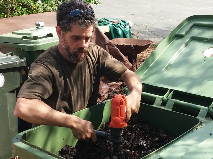 Michael Bradlee, hub manager of the compost operation at Frey Florist on Providence’s West Side, uses a powered auger to aerate compost bins. The hub diverts an estimated 1,000 to 1,500 pounds of food scrap from the landfill monthly. (Kevin Proft/ecoRI News)