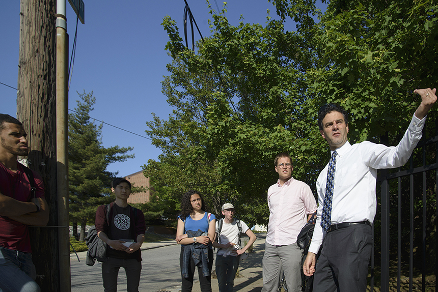 Providence City Council member Bryan Principe, right, and transit advocate James Kennedy, second from right, recently spoke with a small group of local college students, at the intersection of Marvin Street and Service Road 1, about the outdated 6-10 Connector across the street.