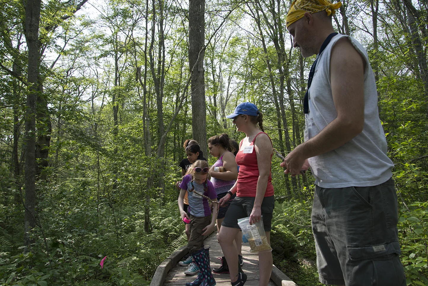 Calcutt Middle School teacher Stephanie Racine and her students mark the spot where they set a no-kill trap that they planned to check the next day. Along the path, students spotted racoon and deer tracks.