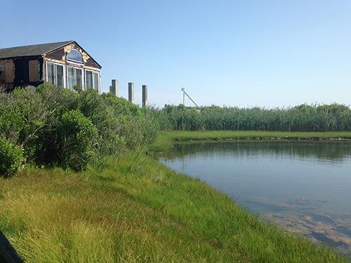 The proposed development would have turned 12 one-bedroom cottages into condominiums with wraparound porches and two-car garages. (Abbey Greene/ecoRI News)