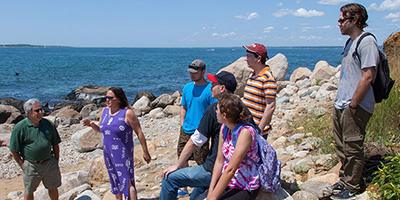 Rhode Island College adjunct professor of geography Jennifer Bonin, second from left, with students during a recent trip to Napatree Point in Westerly, R.I. (RIC)