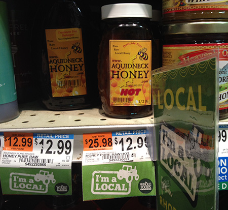 The Whole Foods Market on Waterman Street in Providence clearly markets Aquidneck Honey as a local product. The product’s own labels say the honey is ‘New England Honey,’ ‘Pure Raw Local Honey’ and ‘Pesticide Free.’ (Joanna Detz/ecoRI News)