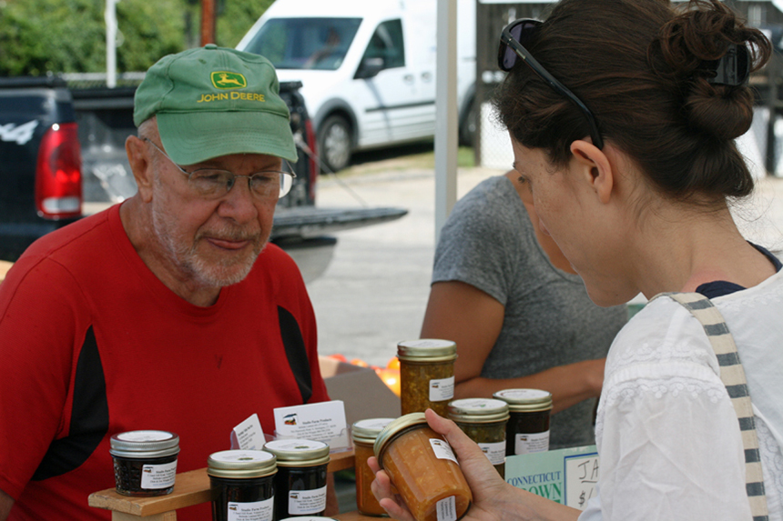 Dick Wingate helps a customer at a recent Stonington Farmers Market.