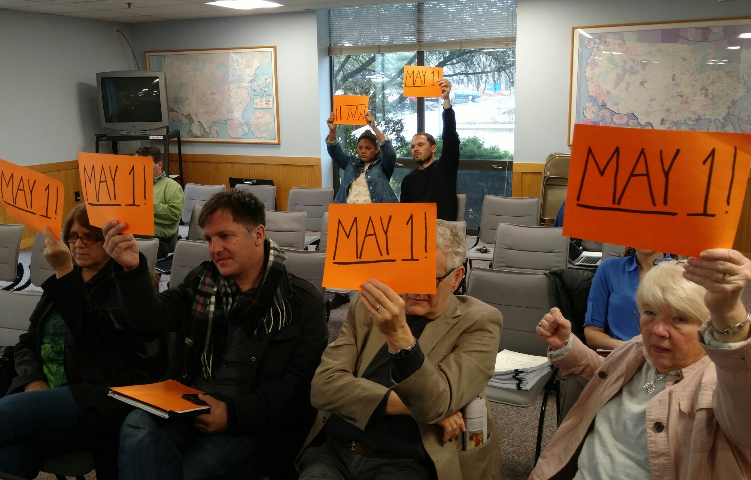 Supporters show the date of a two-week extension of the winter moratorium on gas and electric shutoffs. (Tim Faulkner/ecoRI News)