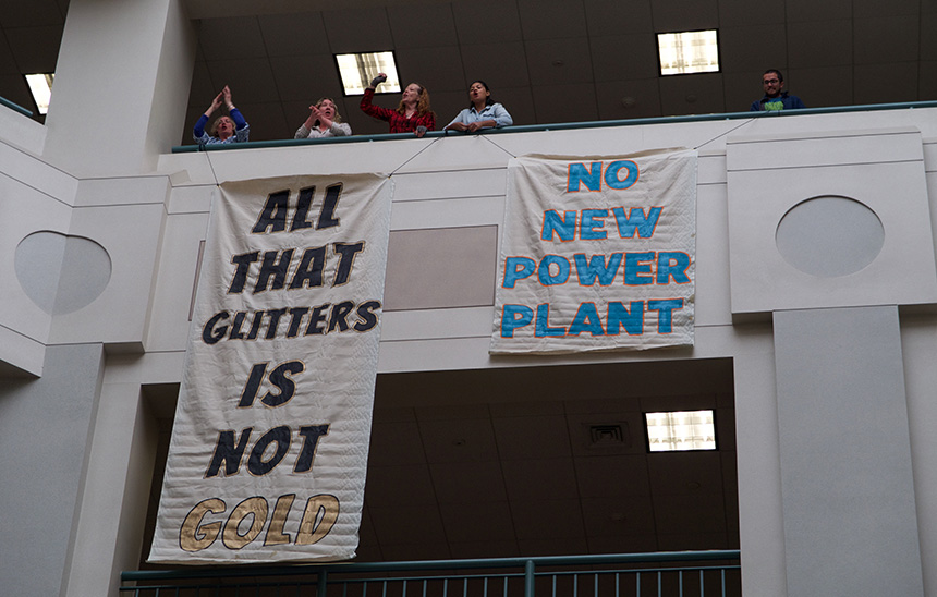 Protesters dropped banners April 18 at the Rhode Island Office of Energy Resources in opposition to the proposed Burrillville natural-gas power plant. (FANG)