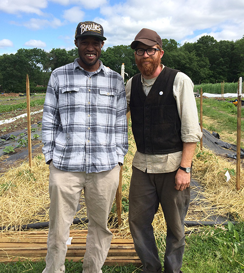 David Kuma, left, is learning to farm under the tutelage of Ben Torpey. (Leigh Vincola/ecoRI News)