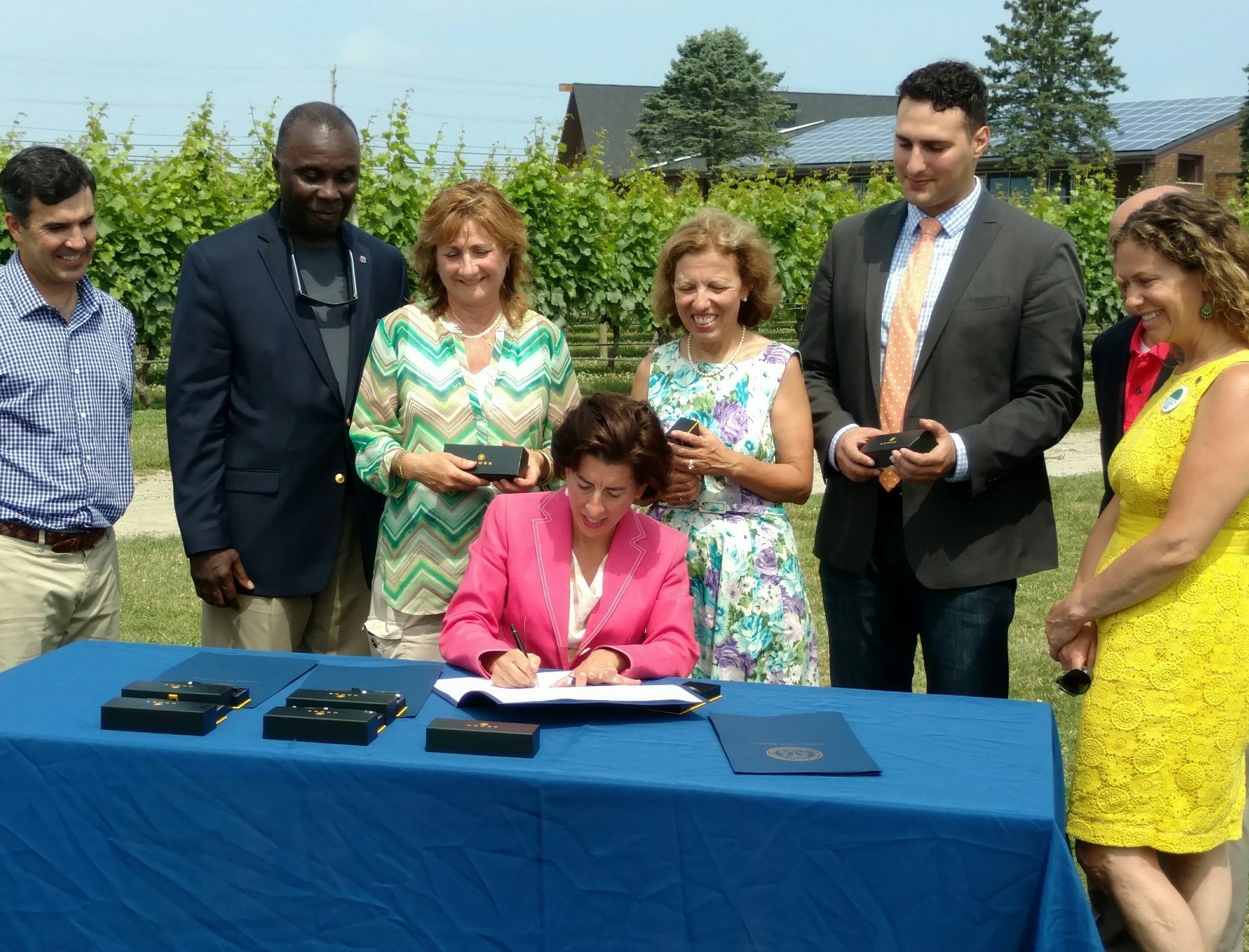 Gov. Gina Raimondo signed two renewable-energy bills into law July 7 at Newport Vineyards in Middletown, R.I. (Tim Faulkner/ecoRI News)