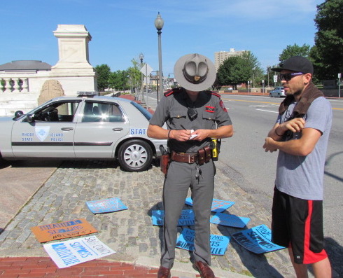 Nick Katkevich of The FANG Collective goes over details of the march with a state trooper.