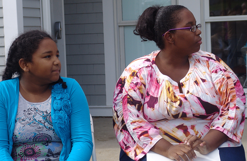 Former Lucy’s Hearth clients Tara D’Ambra and daughter Olivia listen to the speakers during the recent event to celebrate the organization’s new home.