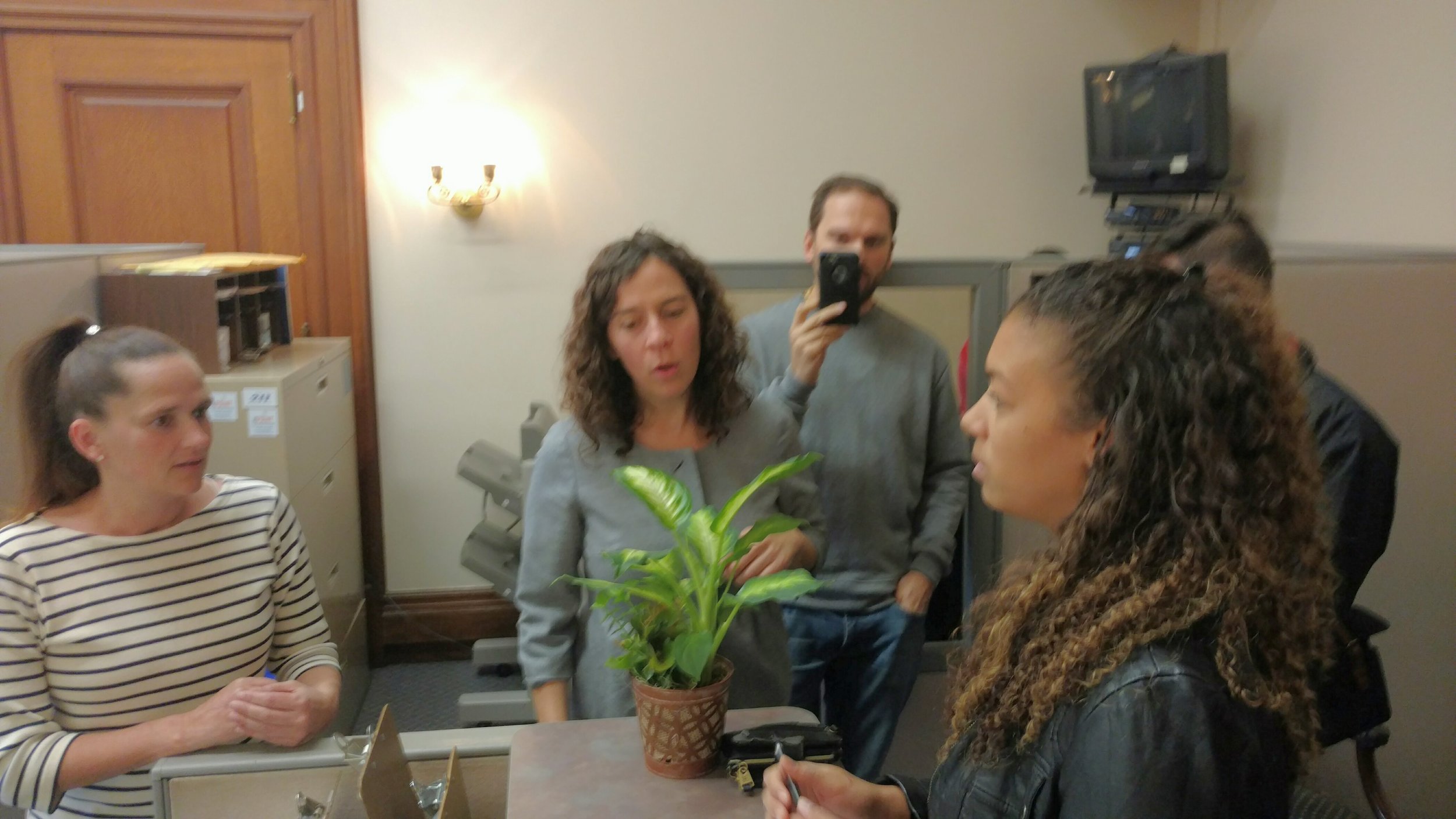 Morgan Victor, right, serves the lawsuit for the Mashapaug Nahaganset tribe to Gov. Gina Raimondo's legal office. (Tim Faulkner/ecoRI News)