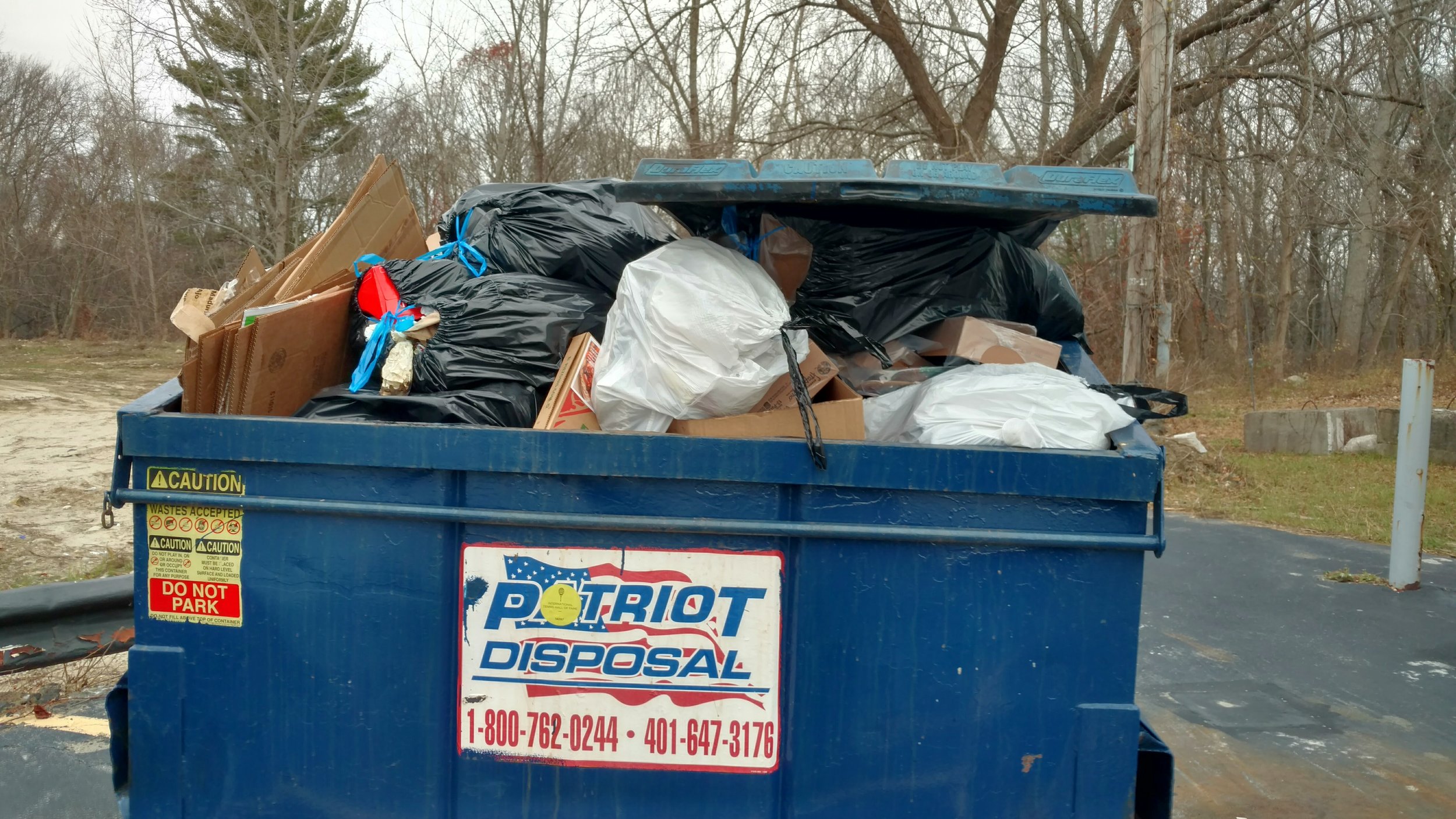 The Ocean Notion uses advocacy and activism to get businesses to comply with recycling laws. This Dumpster sits behind a Valero gas station in Smithfield, R.I. (Tim Faulkner/ecoRI News)