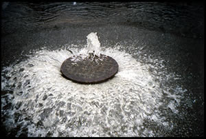 This Rhode Island manhole cover was blown off by a June 2006 sewer overflow. (EPA)