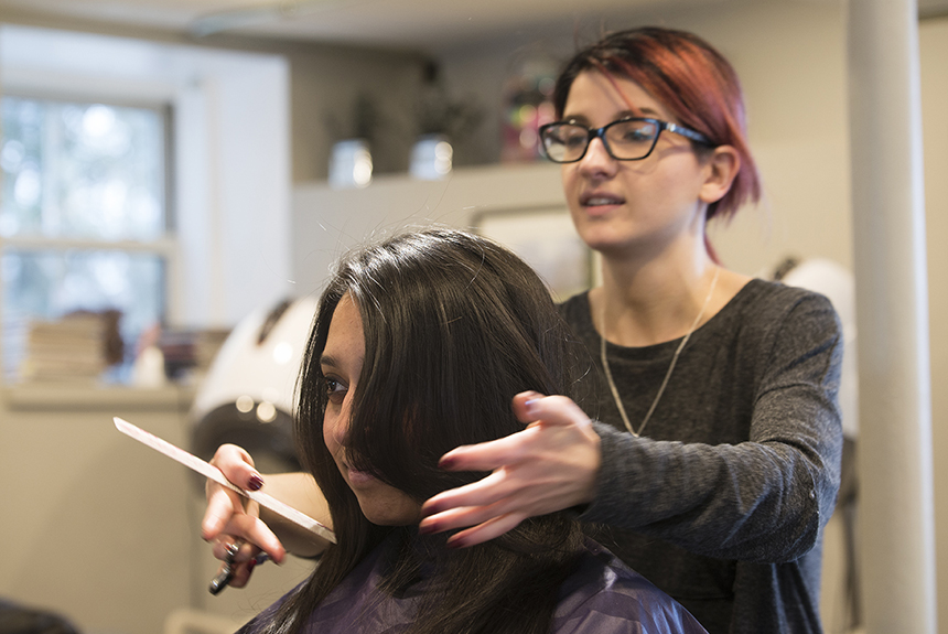 Mariska Moreau, a Flipp Salon & Apothecary stylist, puts the finishing touches on Dionne Rebello’s cut. (Joanna Detz/ecoRI News photos)