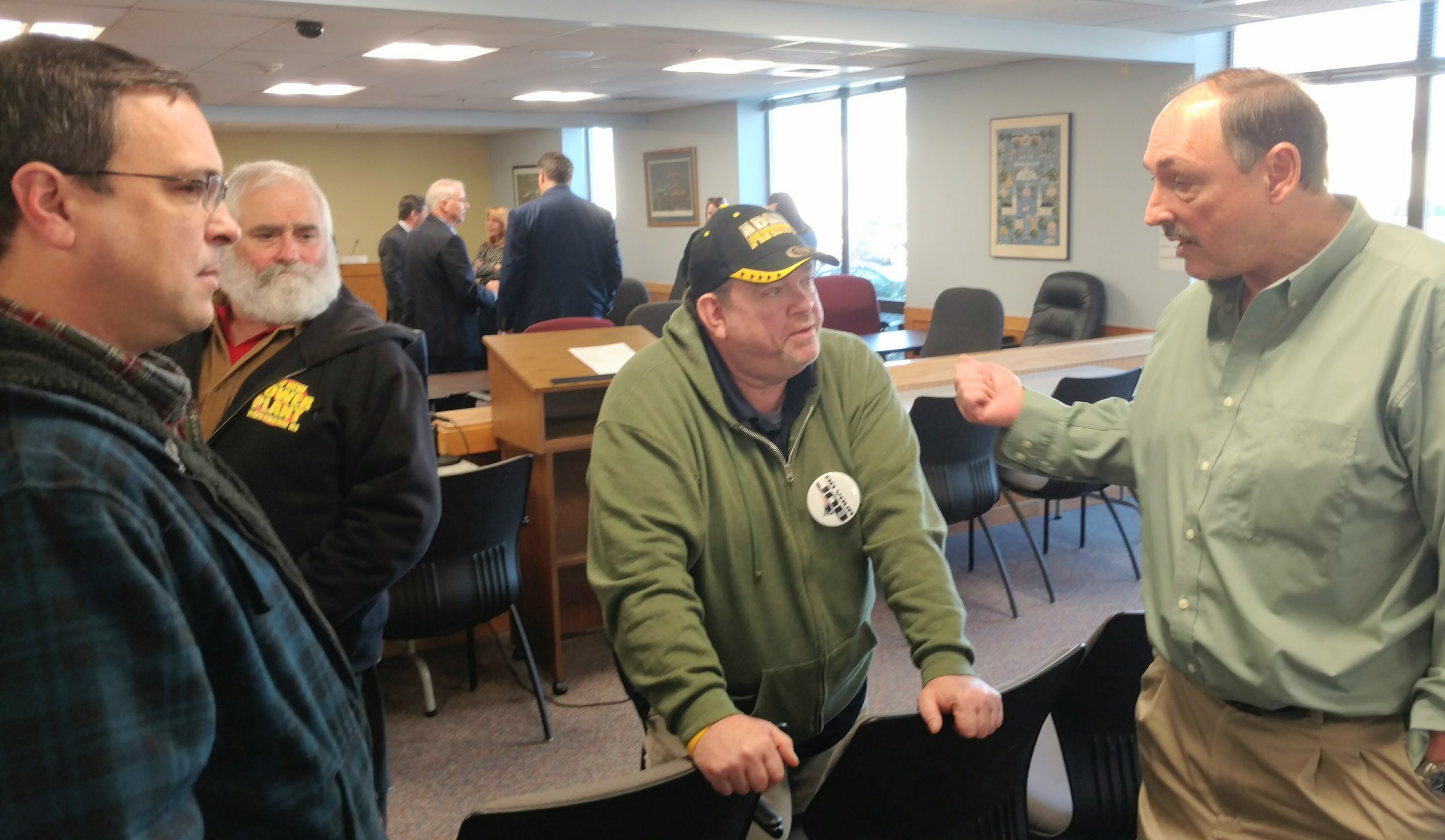 Burrillville Town Council members John Pacheco, left, Ray Trinque, middle, and town administrator Mike Wood talk after the Feb. 6 meeting.