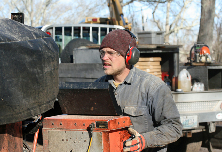 Rob Swanson walks behind the blade as it moves along the carriage. His hands are on the controls. (David Smith/ecoRI News photos)