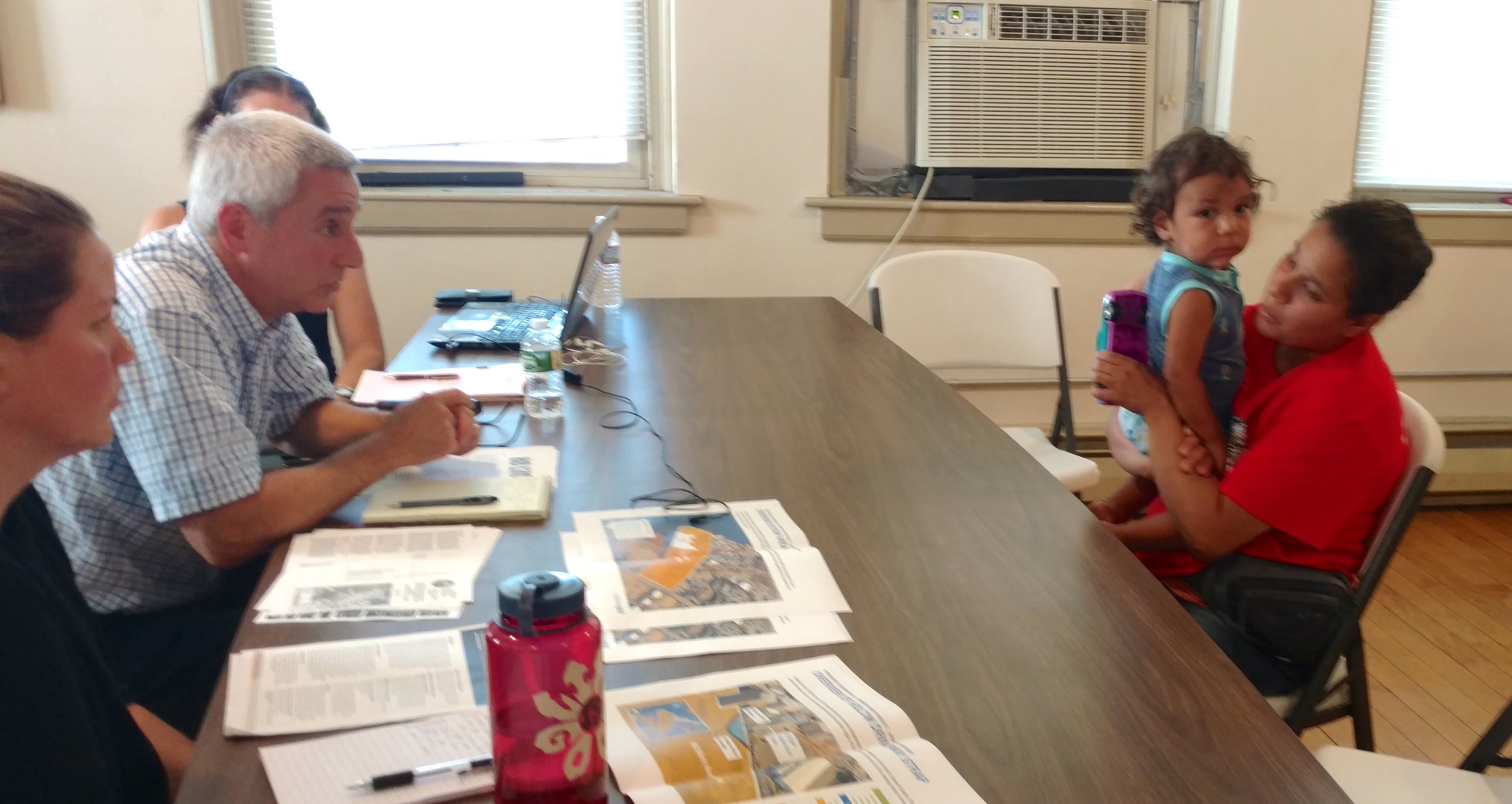 Monica Huertas, right, of South Providence said the face-to-face talk with DEM staffers was intimidating. (Tim Faulkner/ecoRI News)