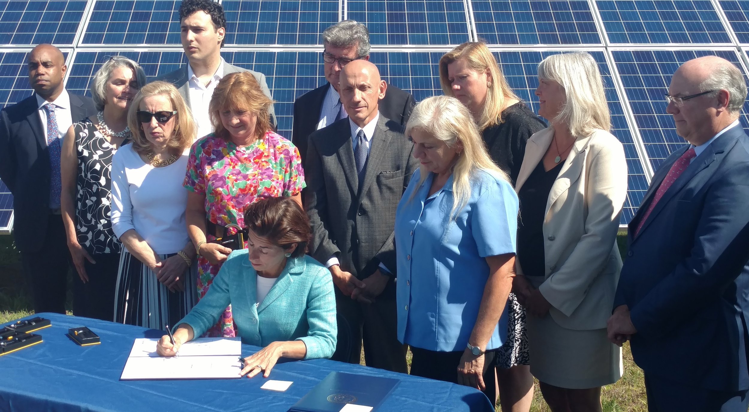 Gov. Gina Raimondo recently signed six renewable-energy bills into law. Is a carbon tax likely for next year? (Tim Faulkner/ecoRI News)
