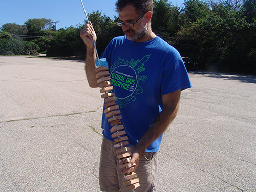 Michael Lombardi holding the substrate upon which northern star coral larvae will be collected. (Frank Carini/ecoRI News)