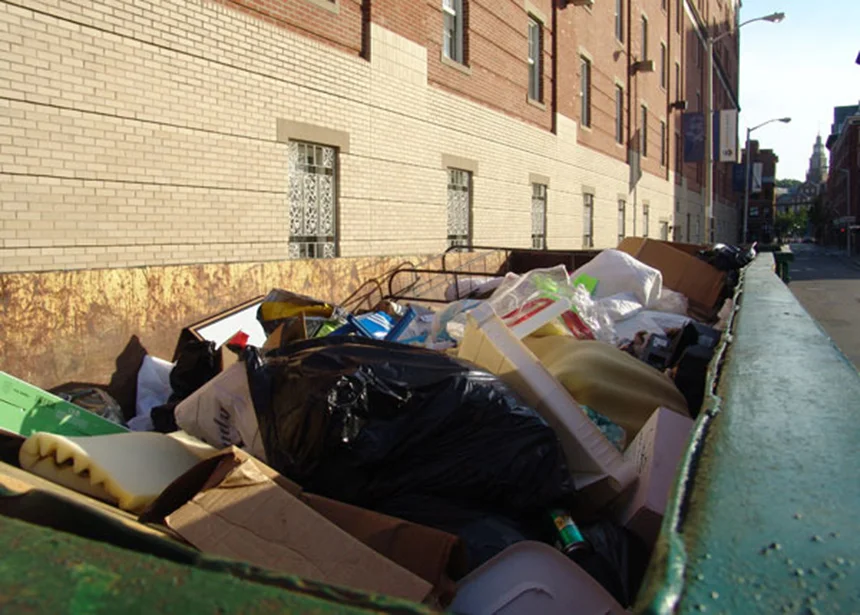 This photo of a Johnson & Wales University Dumpster taken several years ago captures the problem of recyclables being tossed out with trash when students leave for the year. (ecoRI News)