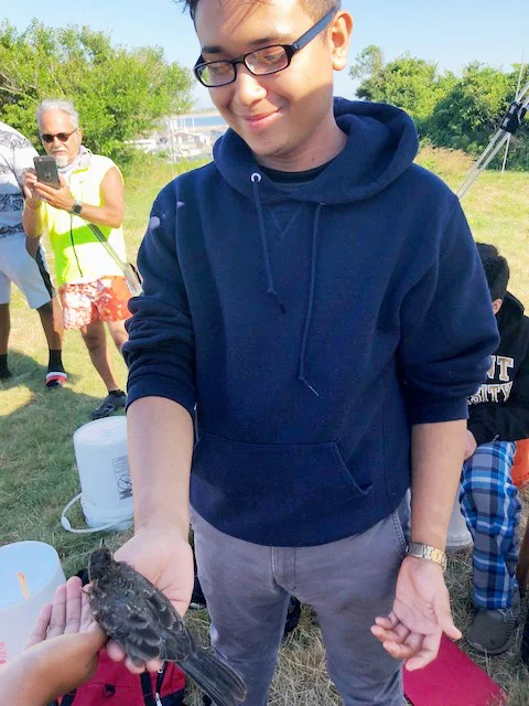 Students visit with Nature Conservancy staffers to learn about bird banding and bird migration on Block Island.
