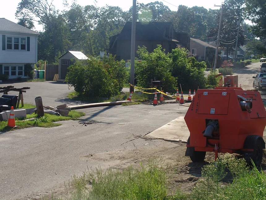 The Cedar Swamp Road worksite in Warwick, R.I., has been bustling with workers and equipment since a sewer line collapsed a week ago. (Frank Carini/ecoRI News photos)