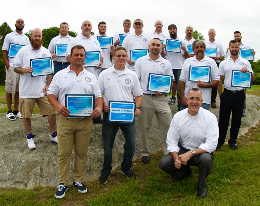 Boot Camp’s sixth class graduated earlier this year. One of the program’s original organizers, Bill Patenaude, is kneeling.