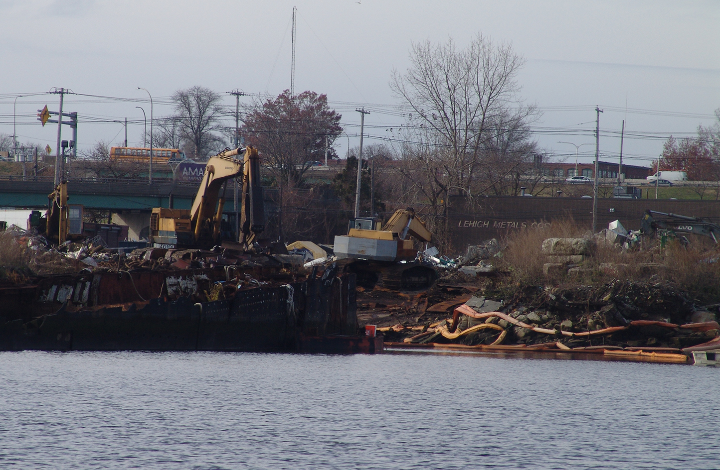 Rhode Island Recycled Metals sits atop a former Superfund and current brownfield in Providence — polluted by polychlorinated biphenyls and capped with 12 inches of fill that some state officials and environmentalists are concerned is eroding. The waterfront business has been operating for nearly decade without all of the required permits. (Frank Carini/ecoRI News)