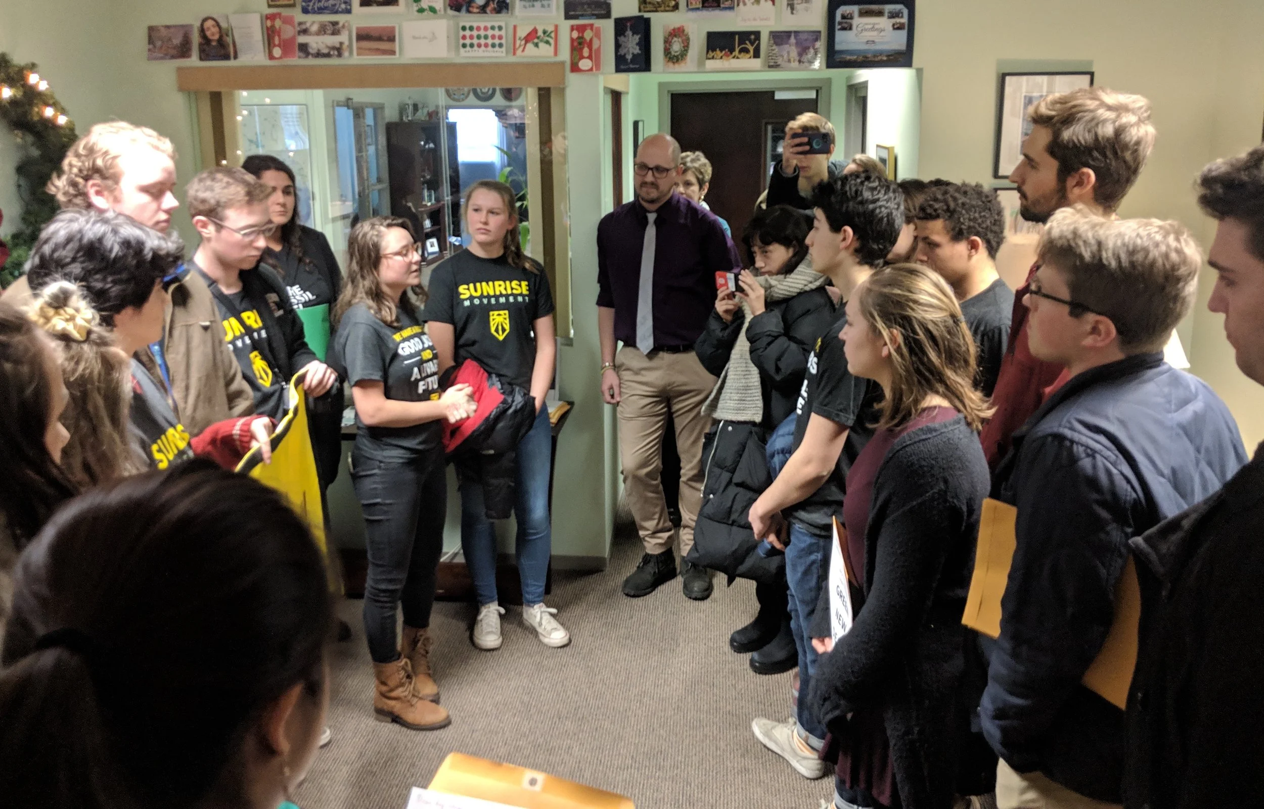 Activists from the Sunrise Movement and other environmental groups at the office of Rep. Jim Langevin, D-R.I. (Tim Faulkner/ecoRI News)