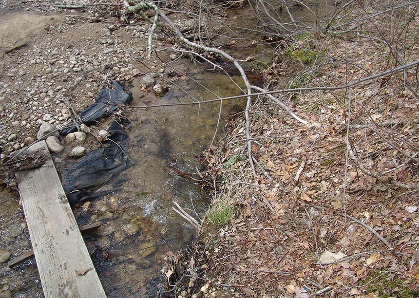 This silt fencing installed by Hopkins Hill Sand & Stone to stop runoff from its quarry washing into the Big River Management Area wasn’t effectively doing its job when this photo was taken last spring. (Frank Carini/ecoRI News photos)