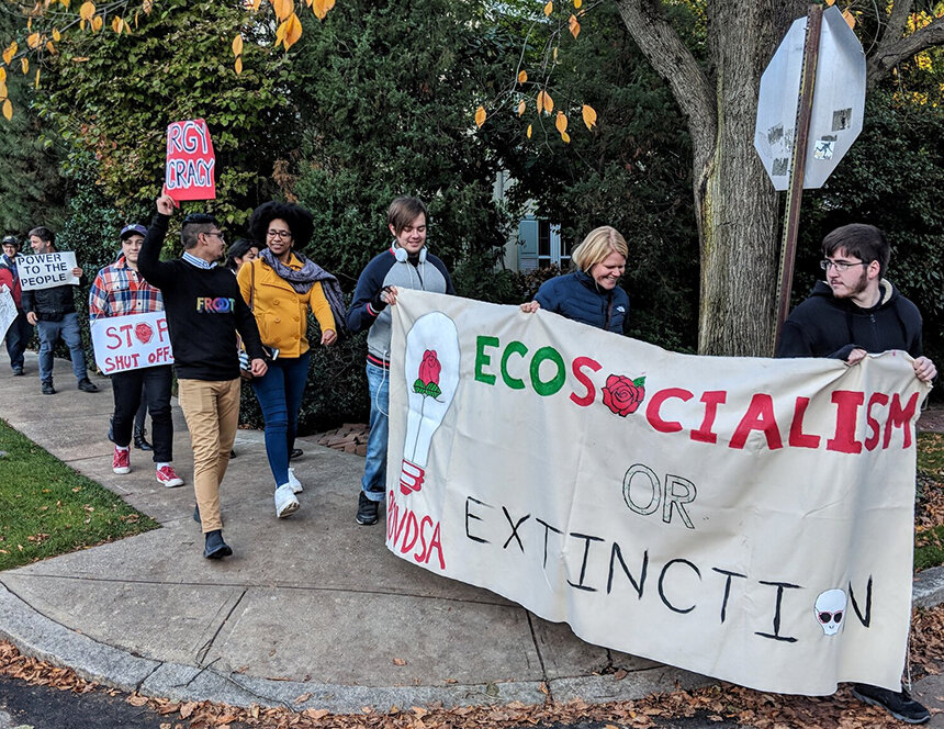 Activists from the Providence Democratic Socialists of America and the George Wiley Center protested Nov. 2 in front of Gov. Gina Raimondo’s house. (Tim Faulkner/ecoRI News)