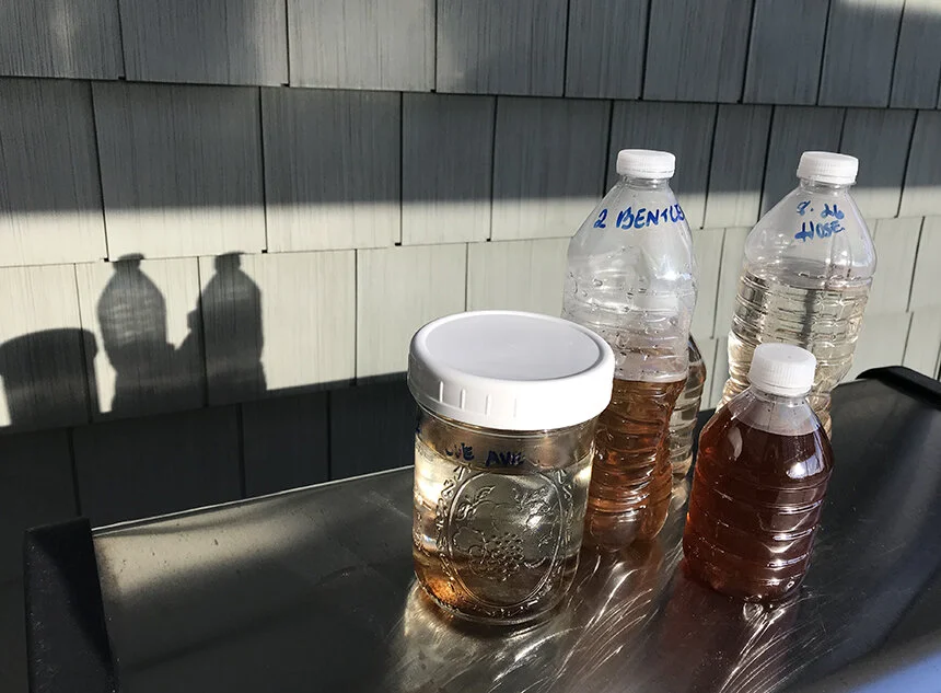 Swansea, Mass., resident Betsy Waring has been saving discolored water in bottles by date. (Frank Carini/ecoRI News)