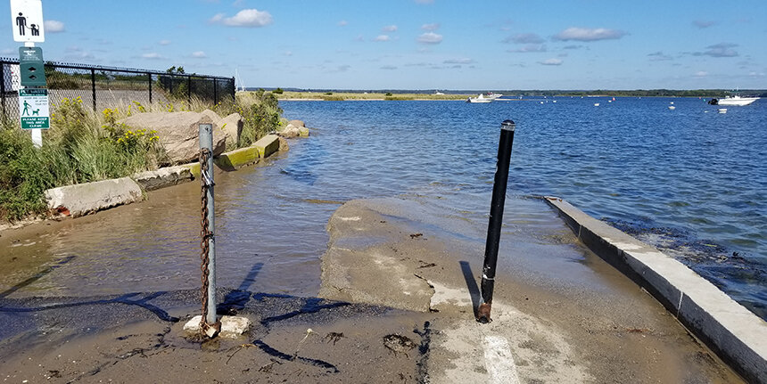 The entrance to Napatree Point at end of Fort Road is seen flooded with water.