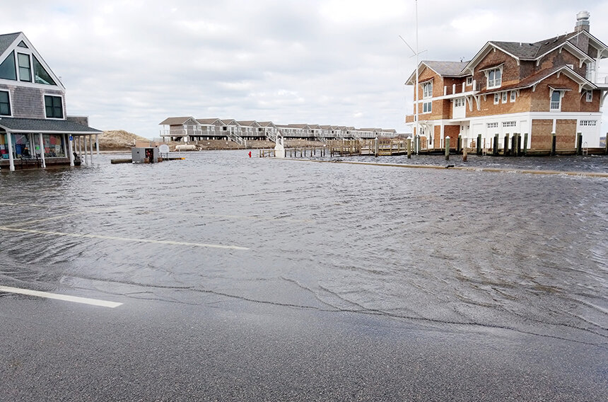 A flooded street with buildings.
